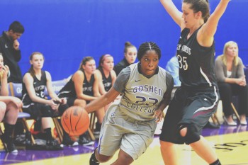 Lynnia Noel, a junior, dribbles around a Holy Cross defender as the Leafs go on to win 59-50. Photo by Maria Bischoff.