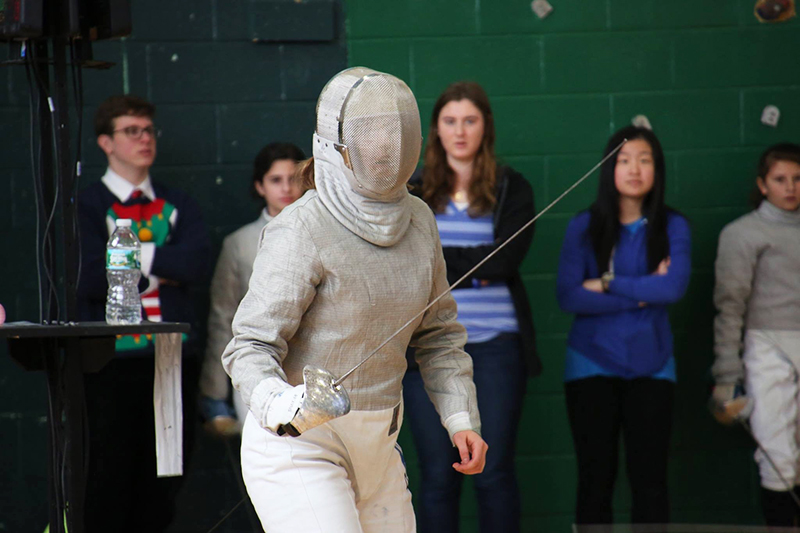 Anja Kenagy wears full fencing gear during a match