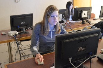 Meghan Gerke works in the computer lab at Goshen College, where the Global Game Jam will be hosted. Photo by Maria Bischoff