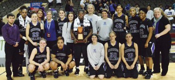 The basketball team pose with the trophy they received after the NAIA DII Nationals semifinals. Photo by Maria Bischoff