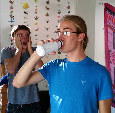 A student drinks a bottle of Soylent while David Jantz looks on in horror