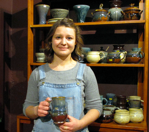 Portrait of Irina with finished ceramics projects