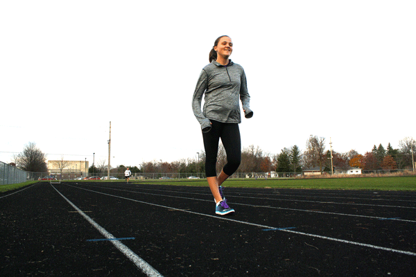 Siana Emery race walks down the Goshen College outdoor track