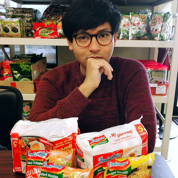 Galed Krisjayanta poses for a picture with a variety of packaged instant noodles