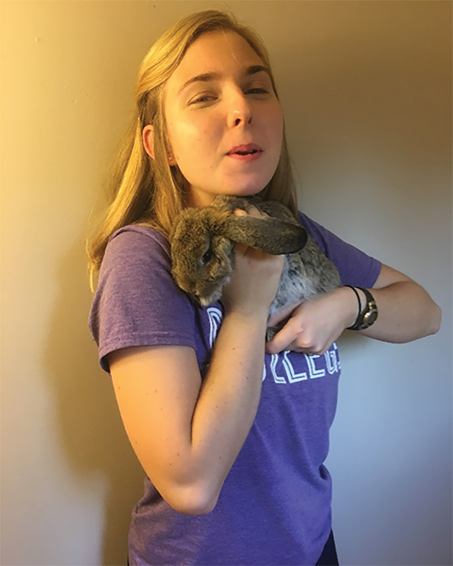 Hannah Thill holds a pet bunny for a picture