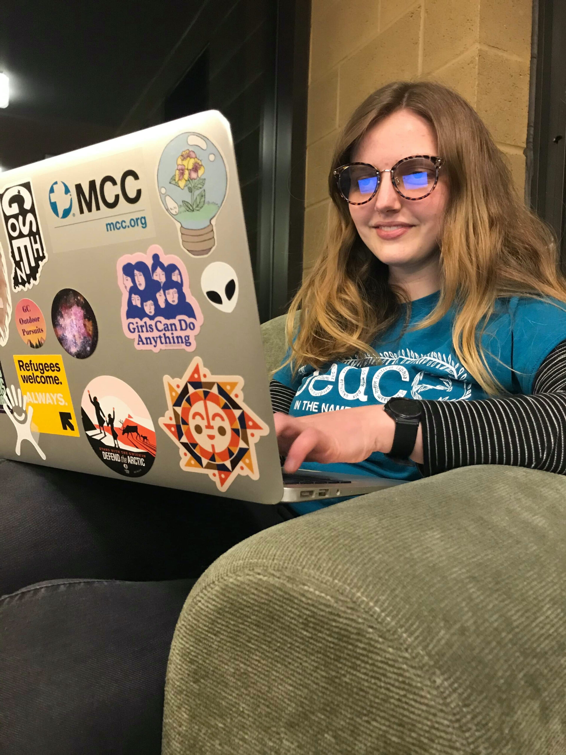 Greta Lapp Klassen wears blue light glasses while working on her laptop