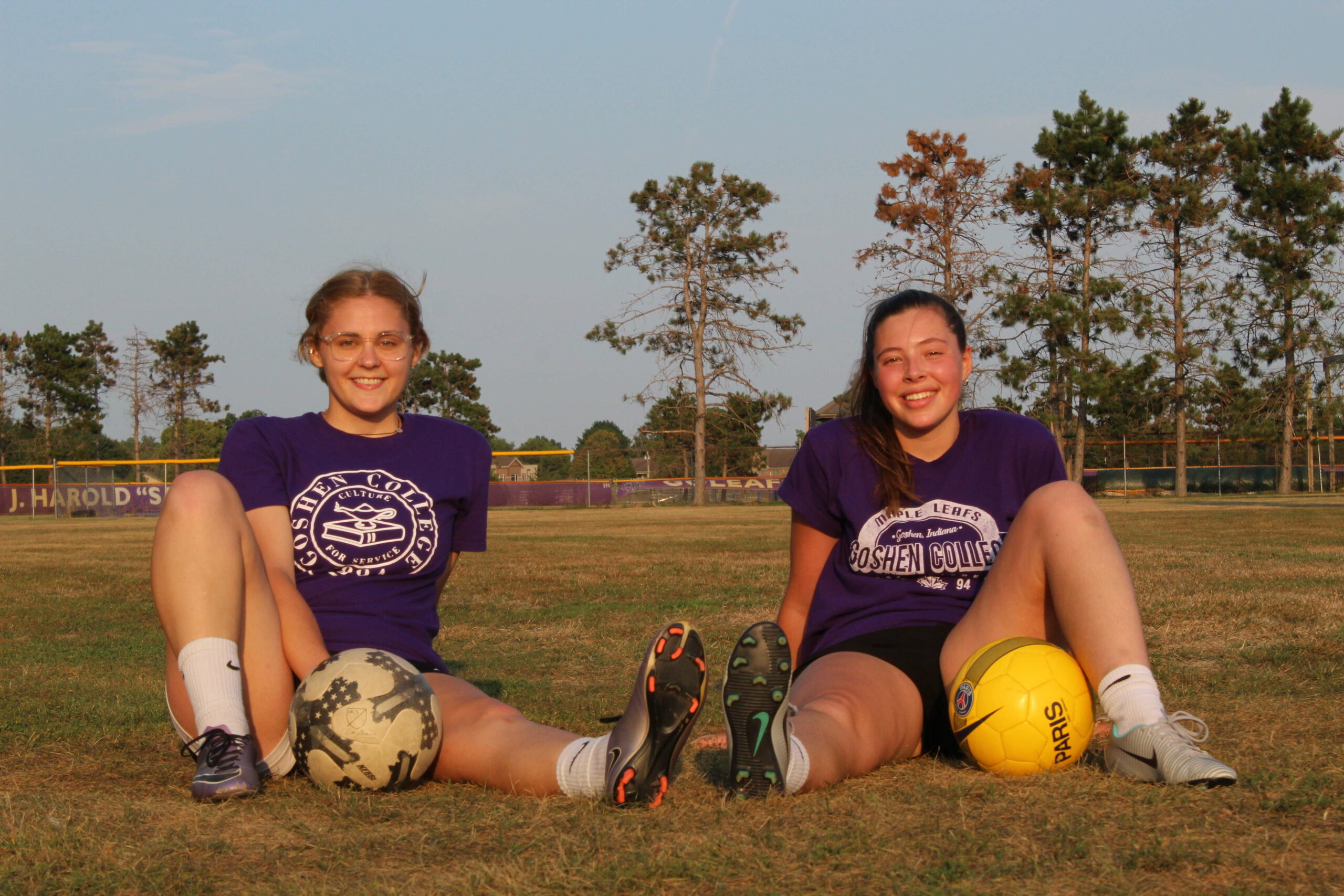 Savannah and Olivia pose with soccer balls
