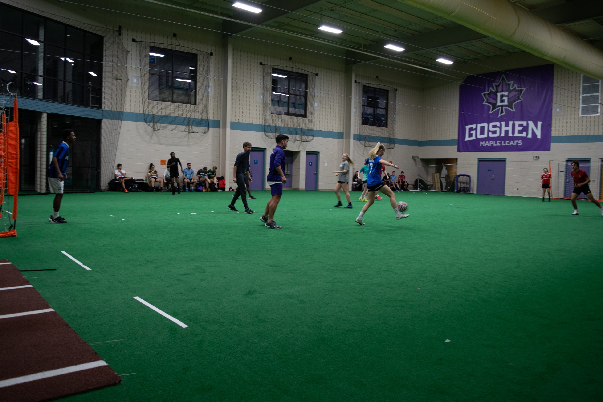 Students play a game of futsal in the RFC turf room.