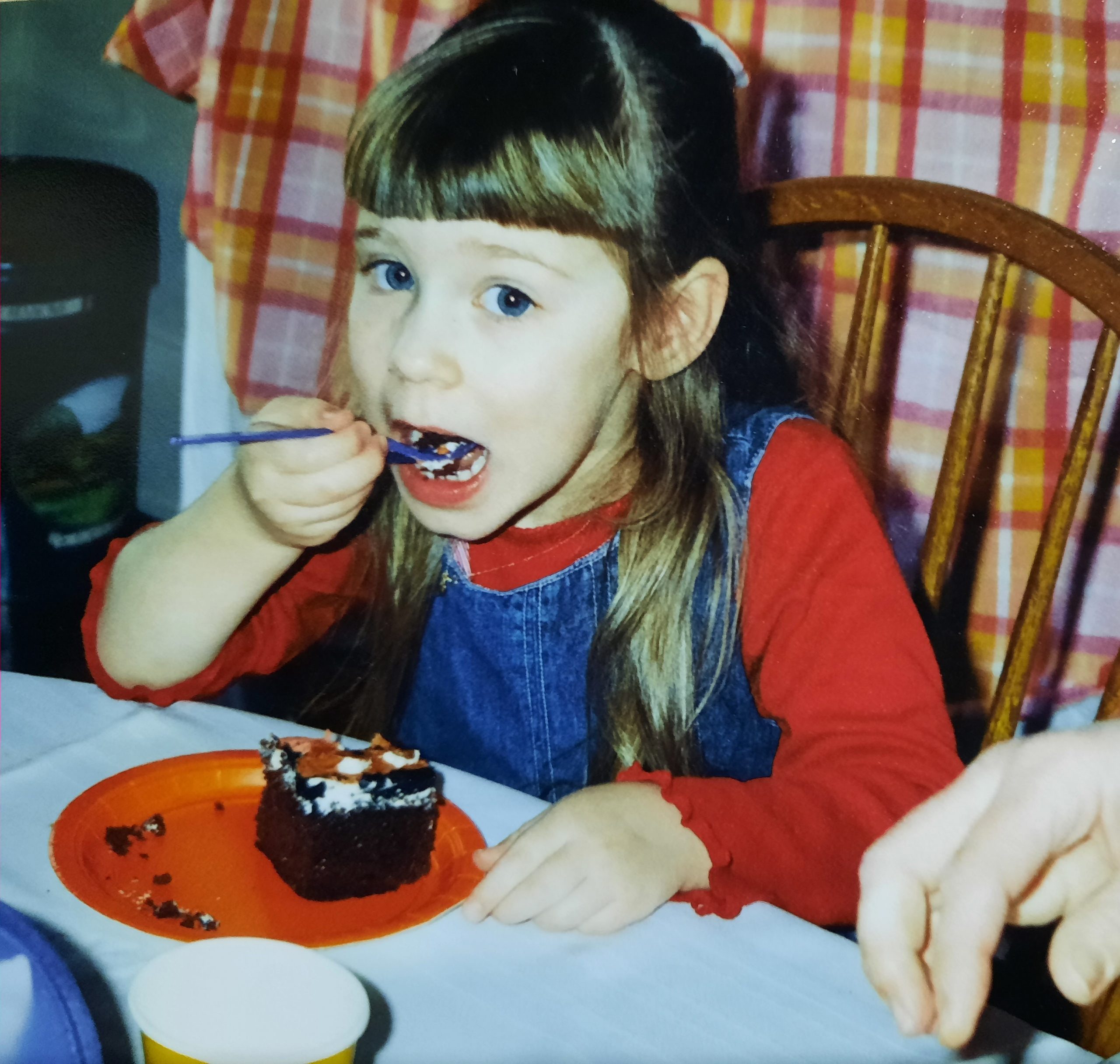 Picture of 4 year-old Leah Kauffman eating cake on her birthday.