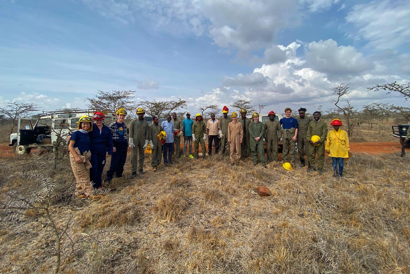 The burn team at the Mpala Research Centre poses for a picture in the savanna.