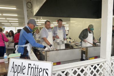 Members of Yellow Creek church stand over a deep fryer